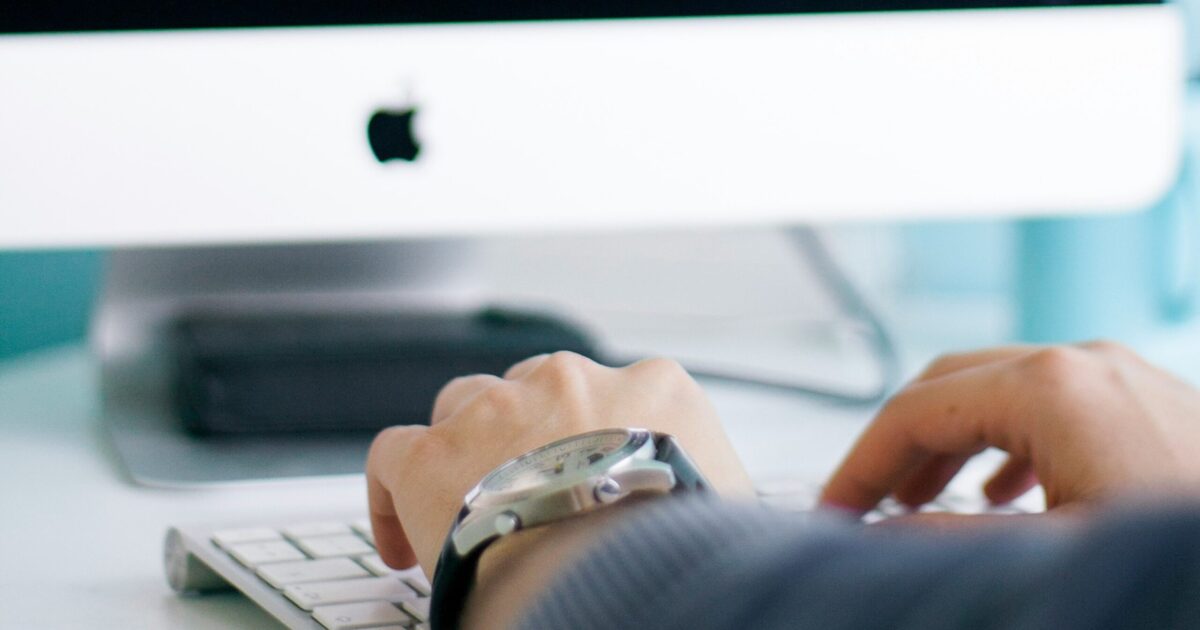 A person working seamlessly on a laptop in a modern office, showcasing uninterrupted productivity with a stable internet connection.