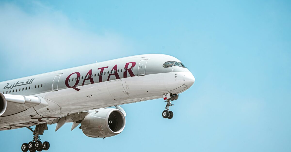 A Qatar Airways plane in flight, equipped with satellite connectivity for enhanced in-flight WiFi.